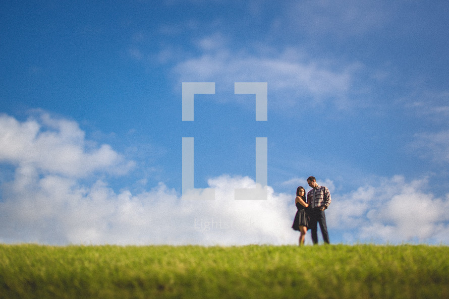 A couple in a grassy field