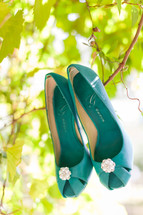 Bright blue shoes hanging in a tree