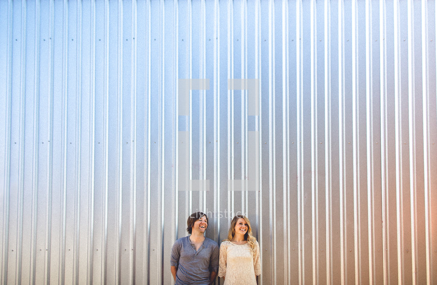 Couple standing in front of metal wall