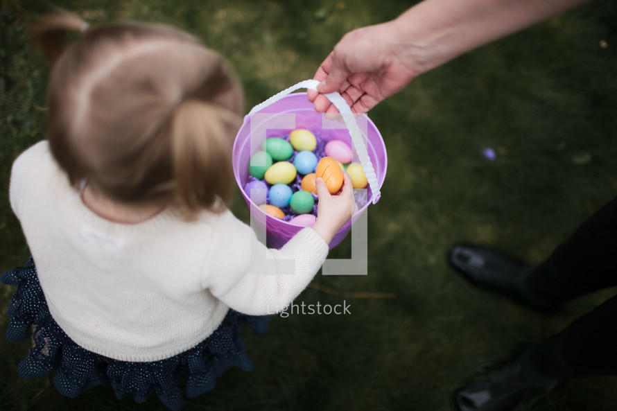 a toddler girl on an Easter egg hunt 