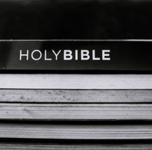 stacked books with Holy Bible 