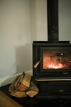 logs next to a fireplace 