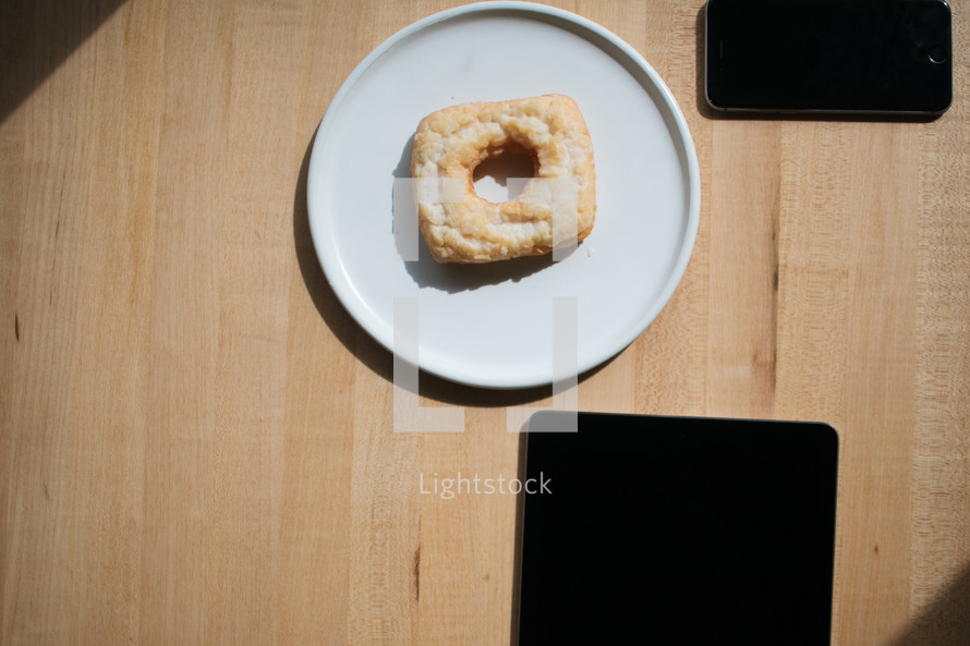square donut on a plate and tablet screen 