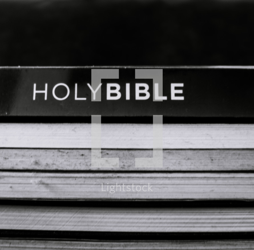 stacked books with Holy Bible 