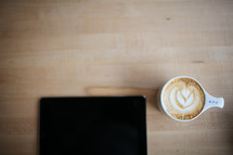 coffee and creamer and an iPad screen 