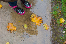 a little girl in rain boots 