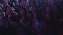 jumping and cheering youth in worship at a youth rally 