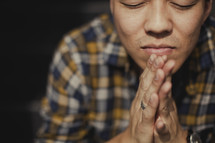 Young Asian man praying