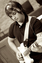 teen playing a guitar 