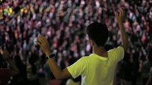 raised hands swaying at a worship rally 