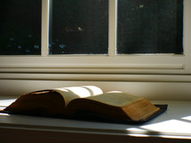 open Bible in a window sill 