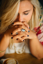 A young woman praying.
