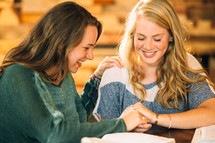 young women praying together at a Bible study 