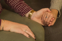teen girls holding hands in prayer at a Bible study 