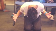 a man praying on his knees 