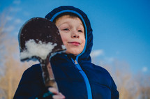 a child in with a shovel in the snow 