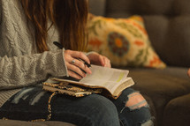 teen girl reading a Bible at a Bible study 