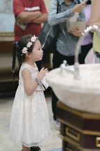 a little girl at a baptism 