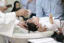 priest baptizing a baby 