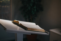 an open Bible on a stand 