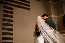bride and military groom kissing 