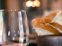 a bowl of bread and a wine glass 