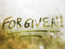 the word forgiven written on fogged glass 