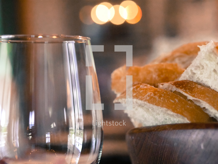 a bowl of bread and a wine glass 