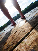 feet standing on a dock 