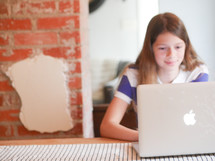 a teen girl on a laptop 