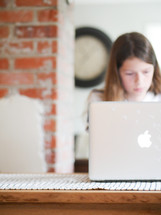 a teen girl on a laptop computer 