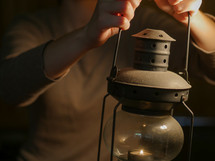 a woman holding a lantern 
