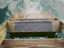 a ladder of a dock in lake water 
