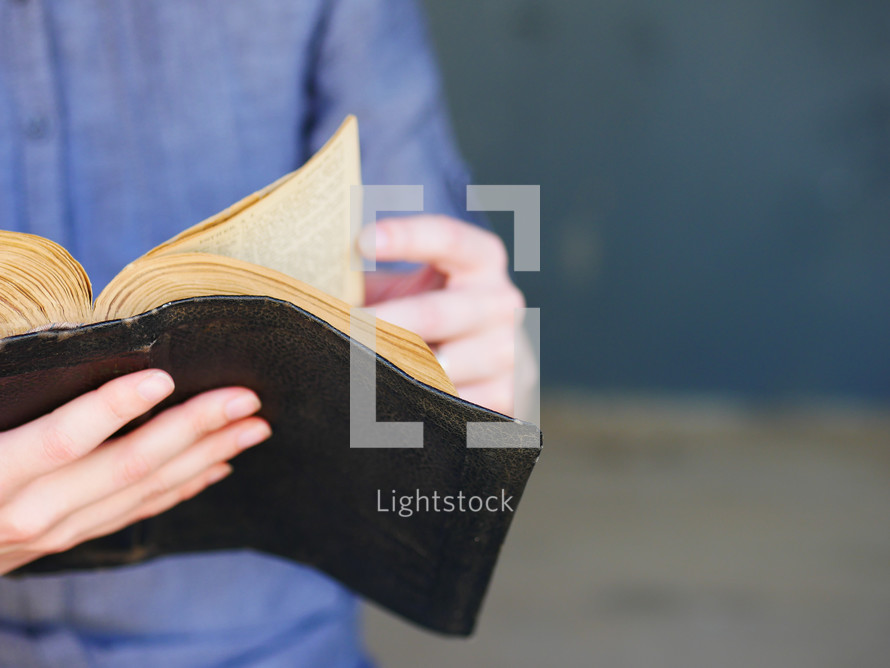 a man reading a worn Bible 