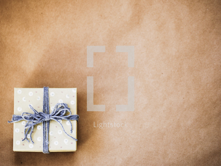 gift wrapped in brown paper and string 