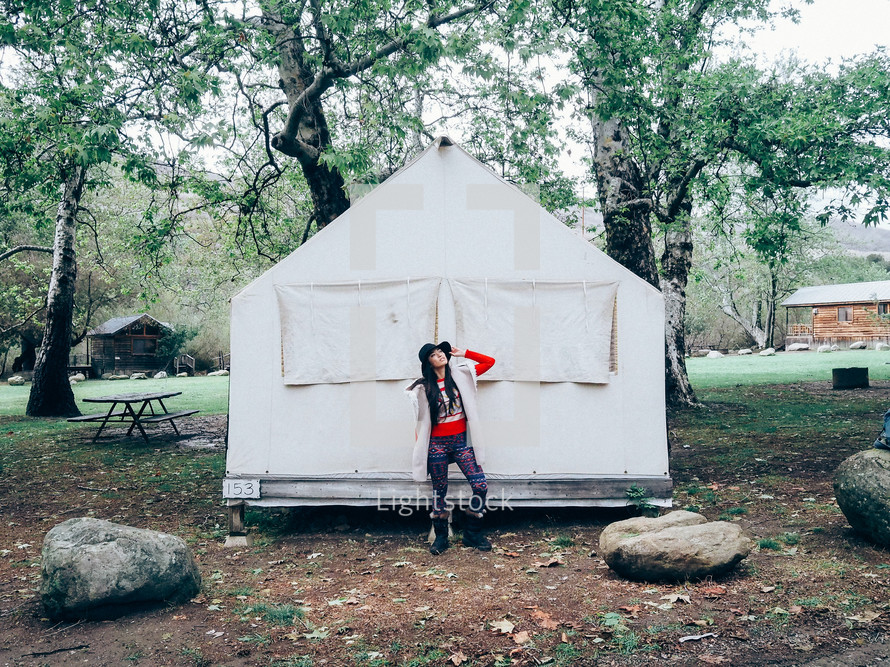 woman standing in front of a tent 