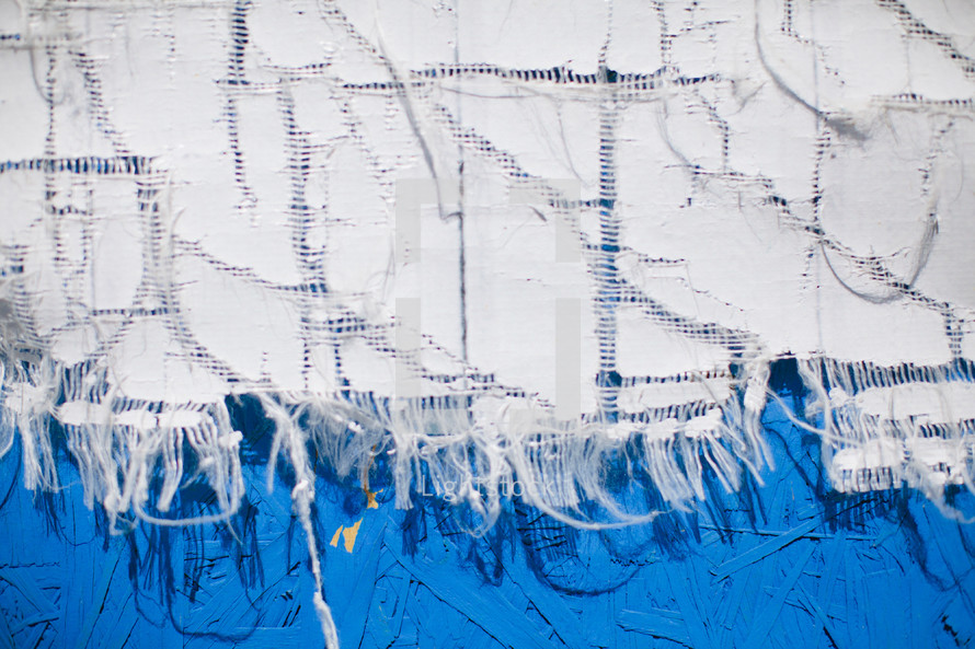 Tattered tablecloth against blue wall