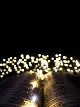 bokeh fairy lights over the pages of a Bible 