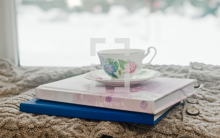 tea cup on a stack of books 