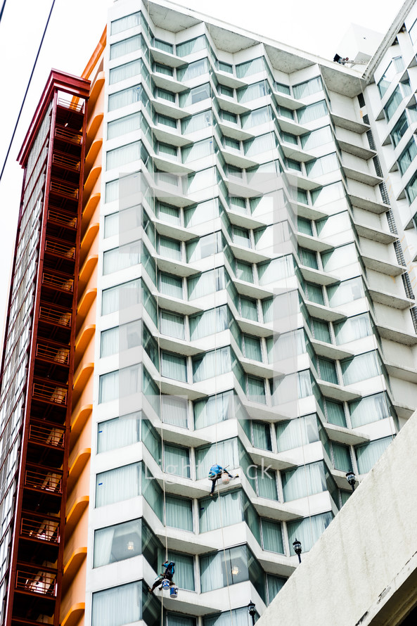 window washers scaling a building 