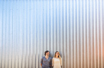Couple standing in front of metal wall