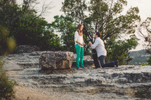 Man proposing to woman outdoors