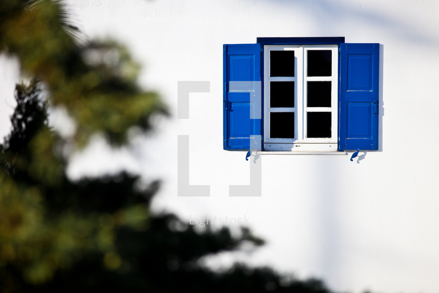 window with blue shutters