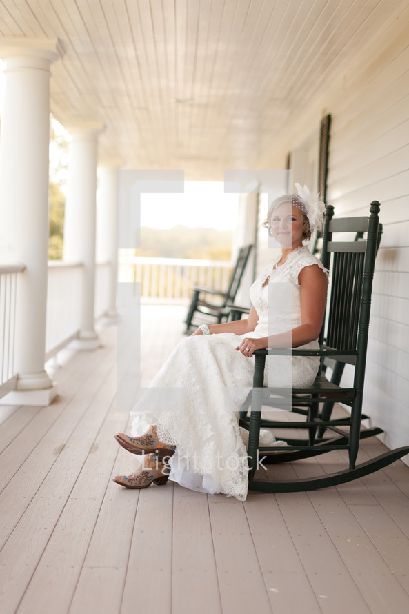 Woman sitting in rocking chair on a porch