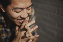 A man praying with fingers laced 