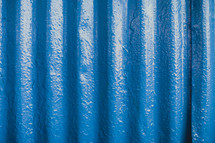 blue wall of a tin building 