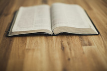 An open Bible on wood