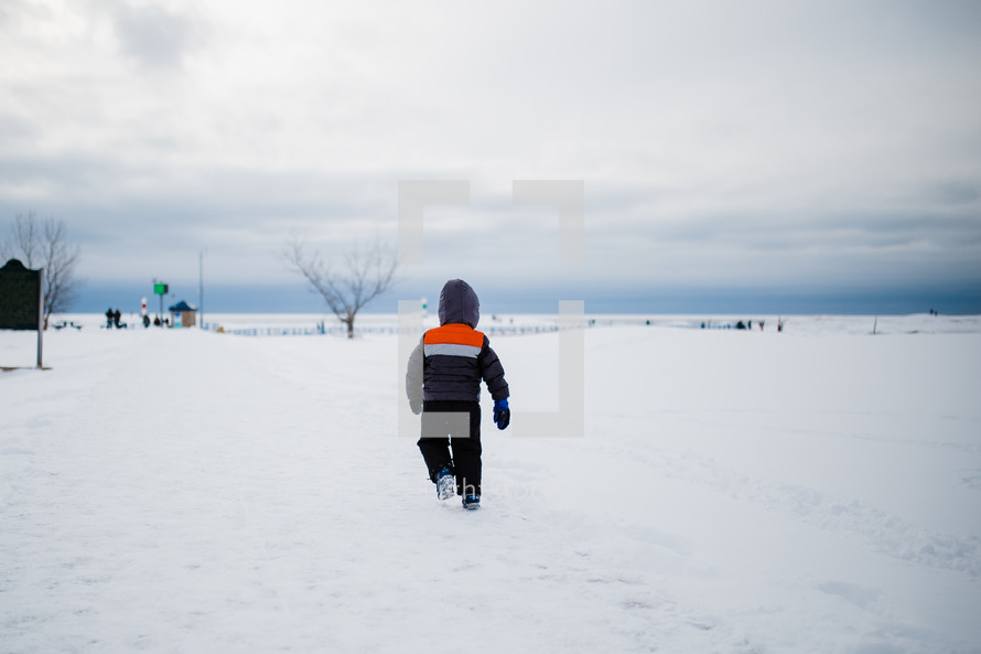 boy running in snow 