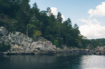 rock cliff around a lake 