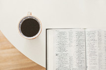 tea cup and an open Bible